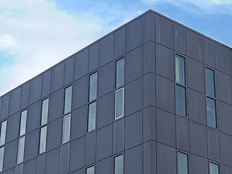 Modern gray office building facade with vertical windows