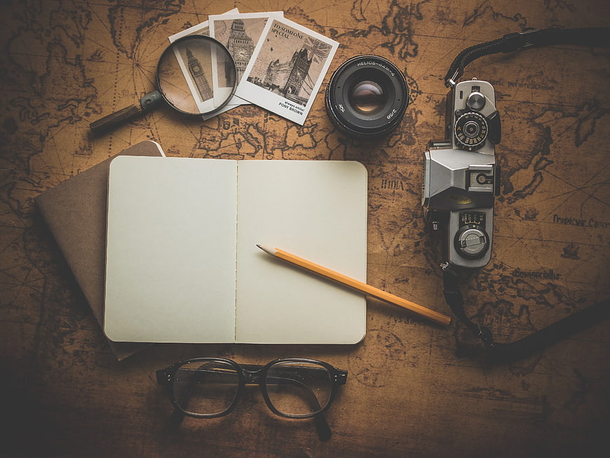 Vintage travel planning flat lay with camera and map