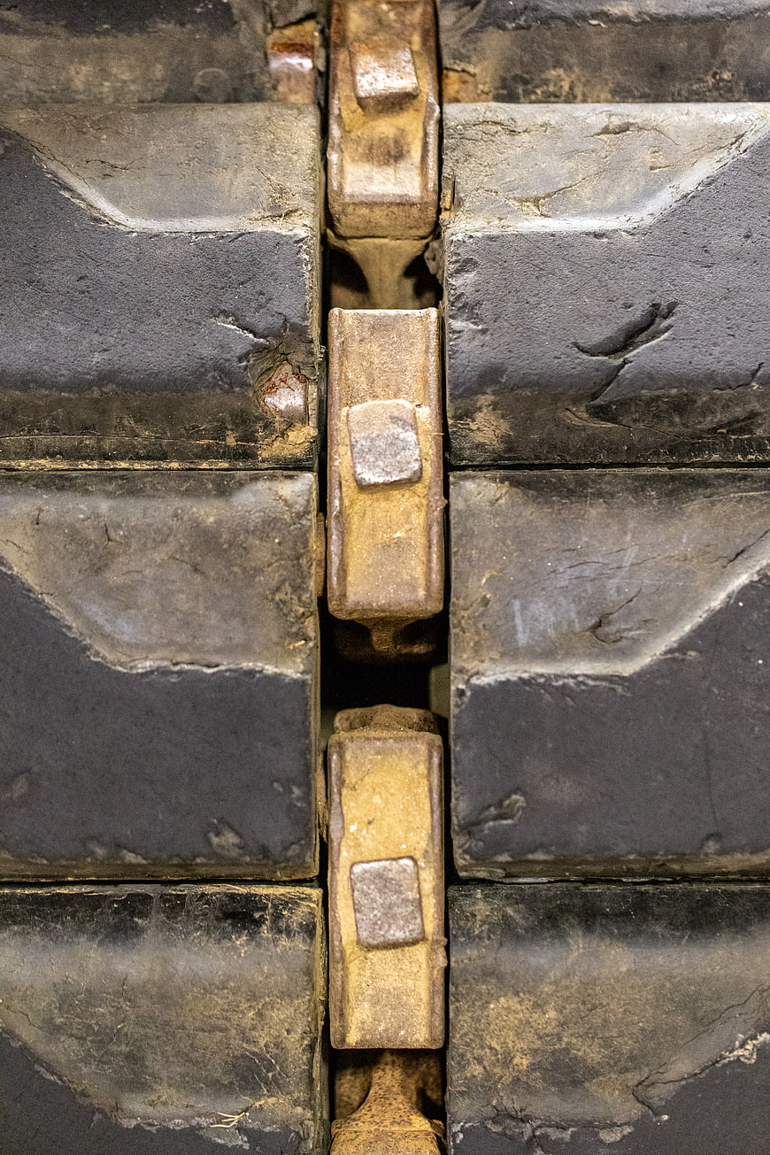 Close-up of worn industrial tank tracks and metal treads