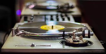 Close-up of vintage turntable with vinyl record and tonearm