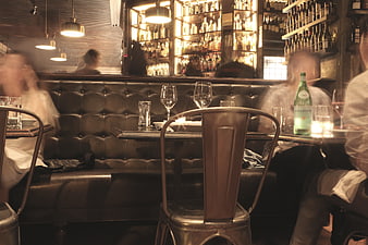 Motion Blur Interior of a Busy Restaurant with Wine Glasses