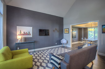 Modern living room with gray walls and green armchair
