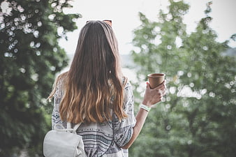 Woman with Coffee Cup Looking at Nature View