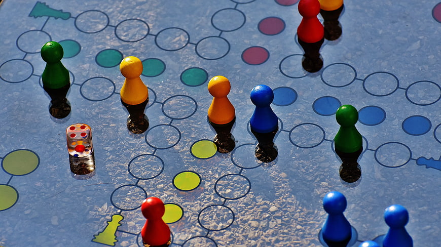 Colorful Board Game Pieces on Blue Surface