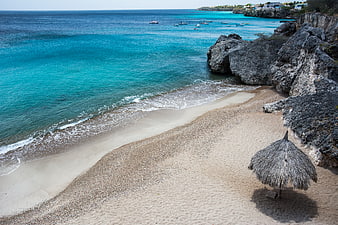 Tropical Beach with Turquoise Water and Thatched Umbrella