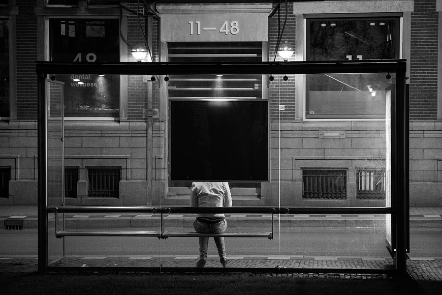 Woman Waiting Alone at Night Bus Stop