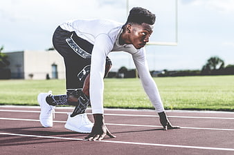 African American Sprinter in Starting Position on Track