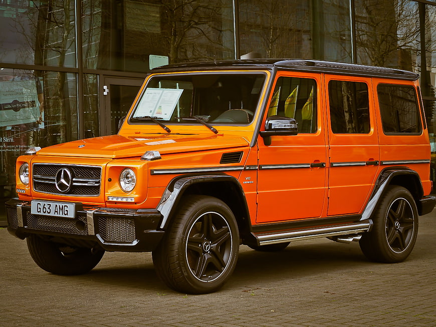 Orange Mercedes-Benz G63 AMG SUV parked outside dealership