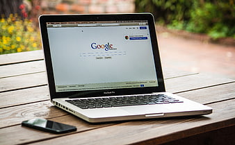 MacBook Pro with Google Search on Wooden Table