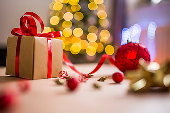Brown Christmas Gift Box with Red Ribbon and Bokeh Lights