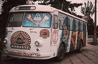 Vintage white bus converted into a mobile coffee shop with colorful murals