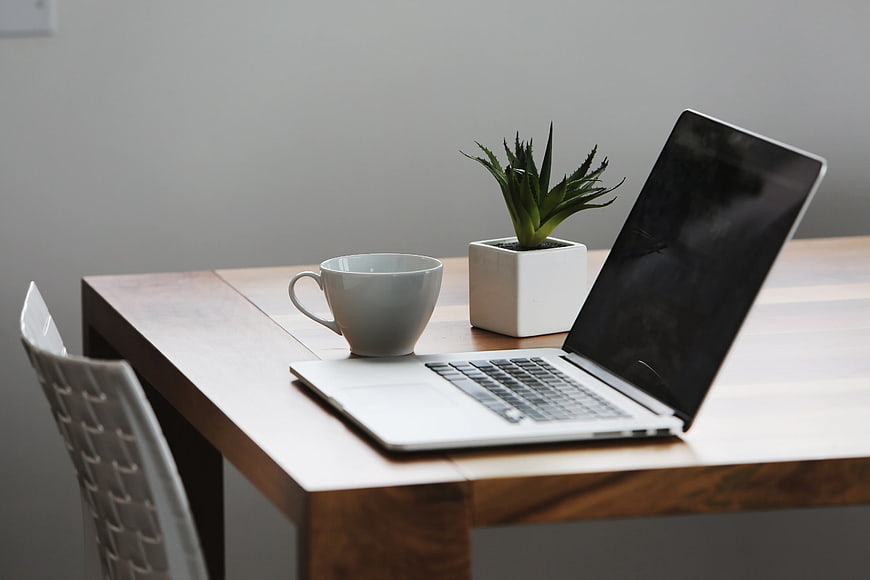 Minimalist Workspace with Laptop, Coffee Cup, and Succulent