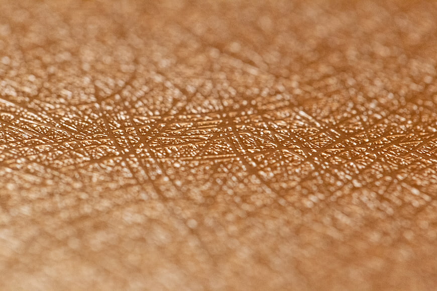 Close-up of textured gold metallic surface with abstract pattern