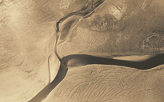 Aerial view of winding river through desert landscape