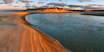 Serene Coastal Landscape with Sand Dunes at Sunset