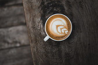 Top View Latte Art Coffee on Rustic Wooden Table