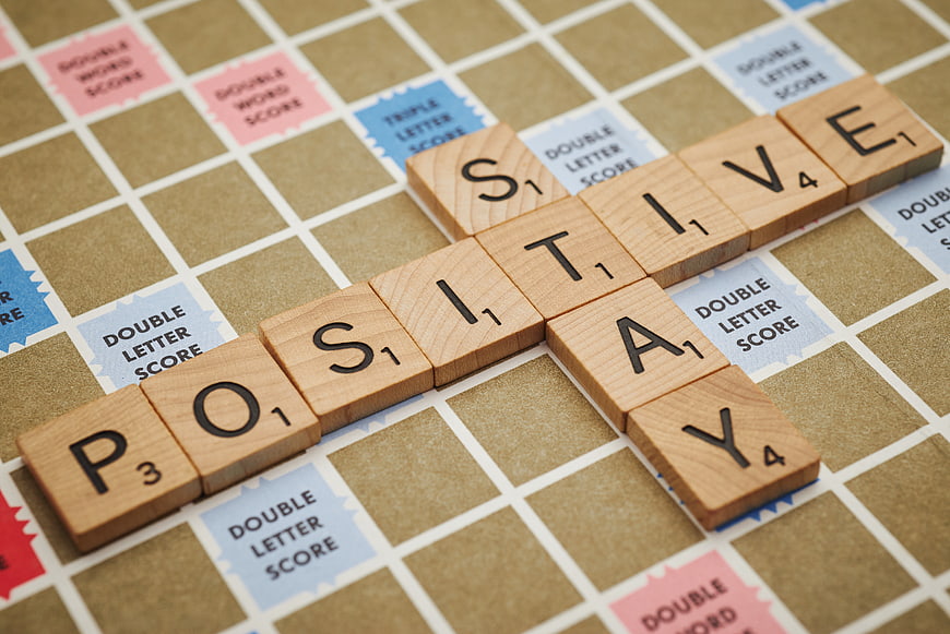 Positive Stay Scrabble Tiles on Game Board