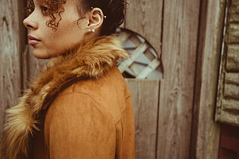 Profile portrait of stylish woman in brown fur coat