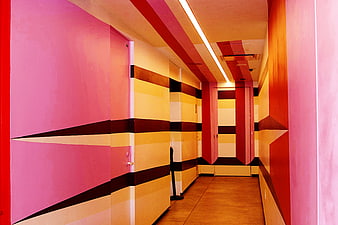 Colorful geometric hallway with pink and yellow walls