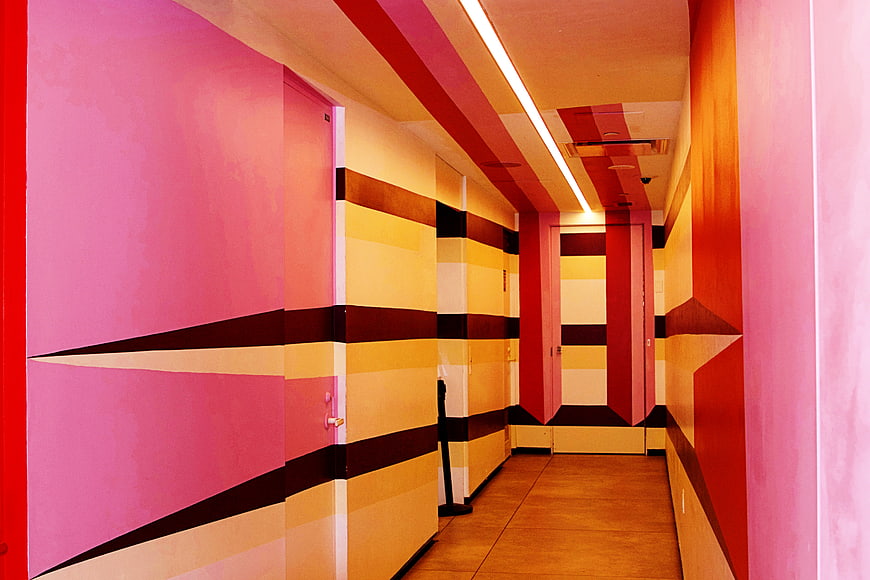 Colorful geometric hallway with pink and yellow walls