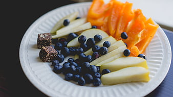 Healthy fruit snack plate with blueberries, pears, and papaya