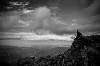 Silhouette of Hiker on Rocky Mountain Peak Overlooking Valley