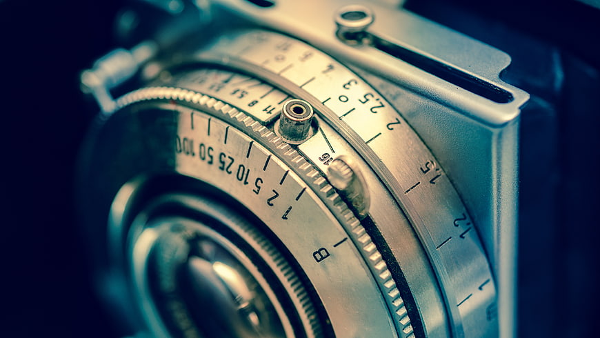 Close-up of vintage camera lens aperture and shutter speed dials