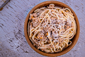 Top View of Spaghetti Bolognese in Rustic Clay Bowl