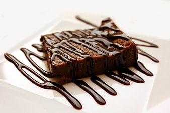 Square Chocolate Brownie Drizzled with Dark Chocolate Sauce