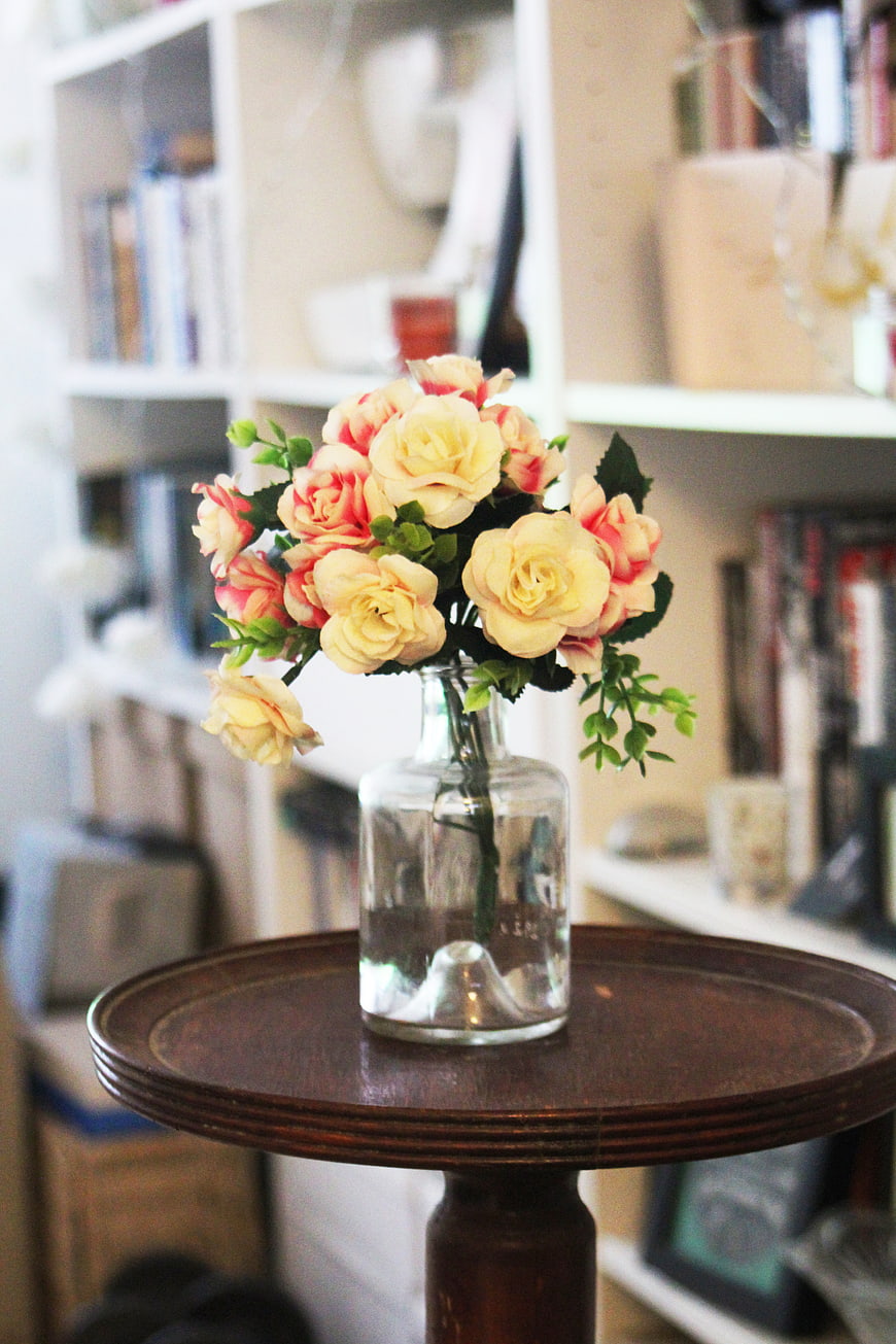 Yellow and Pink Artificial Roses in Glass Vase on Wooden Table