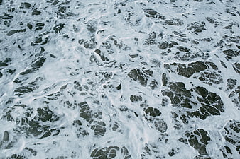 Aerial View of Foamy Ocean Waves and Sea Foam