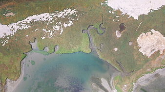 Aerial View of Arctic Tundra, River Delta, and Snow Patches