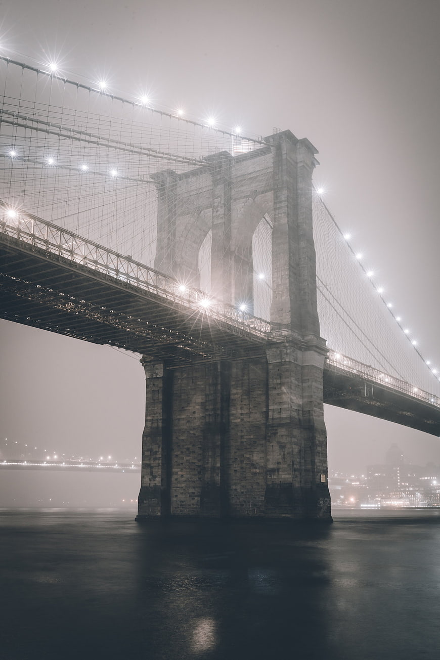 Brooklyn Bridge in Fog at Night with City Lights