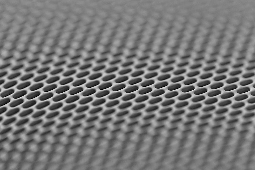 Close-up of perforated metal mesh texture background