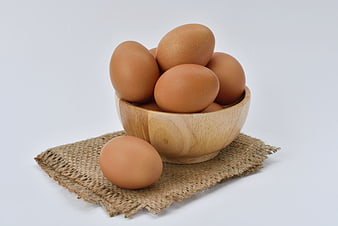 Brown Eggs in Wooden Bowl on Burlap Cloth