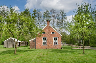 Traditional Dutch Brick House in Green Landscape