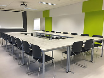 Modern Conference Room with U-Shaped Table and Green Walls