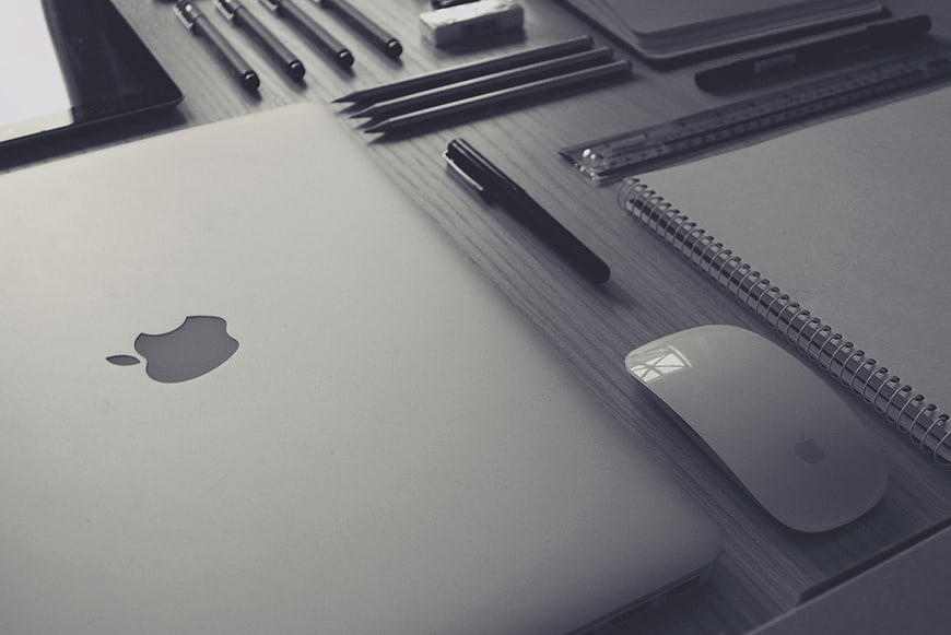 Minimalist Workspace with Laptop, Mouse, and Stationery