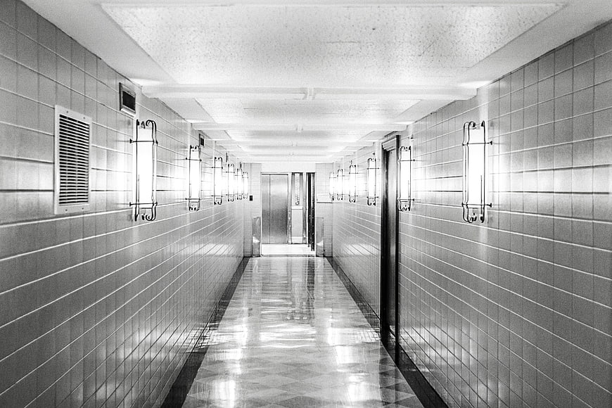 Black and white tiled hallway with vintage lights