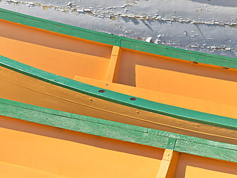 Abstract detail of orange and green wooden boat hull