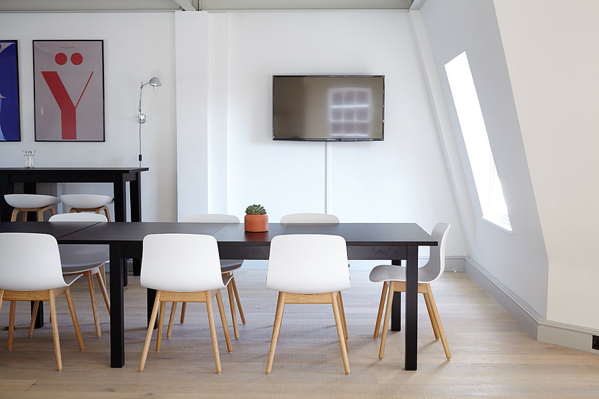 Modern minimalist dining room with black table and white chairs