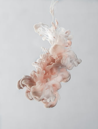 Abstract pink and white ink swirling in water
