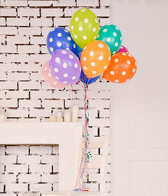Colorful Polka Dot Balloons on White Brick Wall