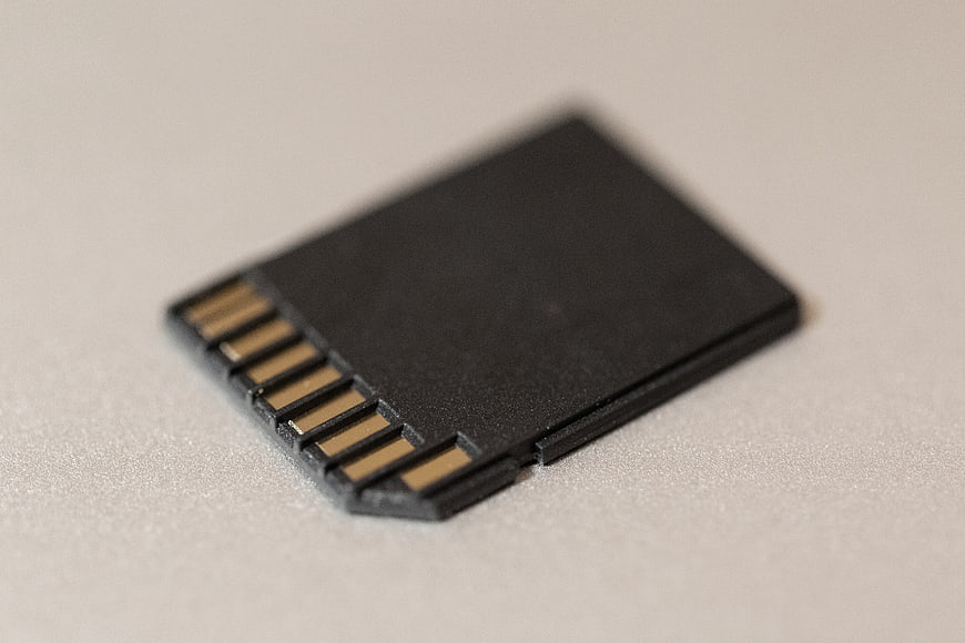 Close-up of black SD memory card on white background