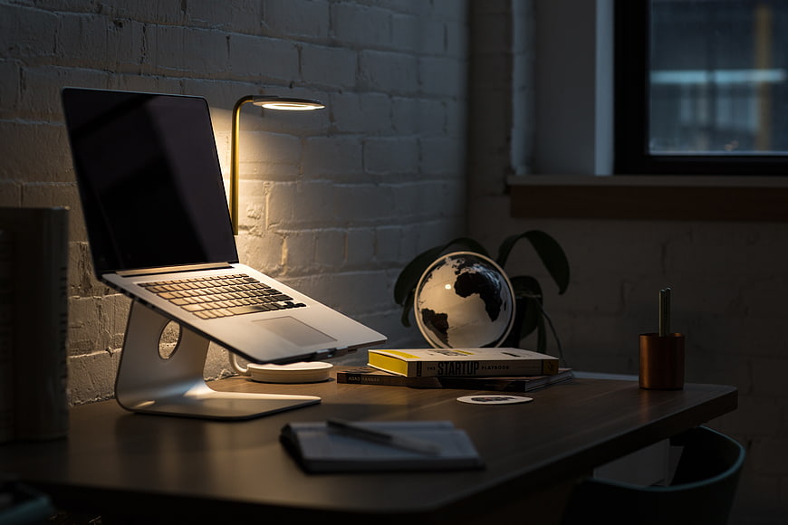 Modern Workspace with Laptop and Desk Lamp