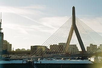 Cable-stayed bridge in winter cityscape with traffic
