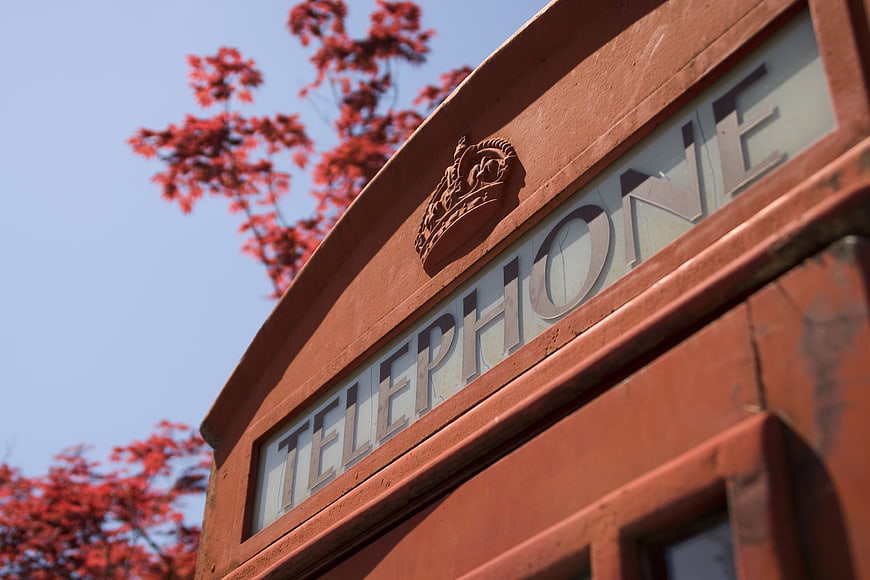 Close-up of classic red British telephone box with crown emblem