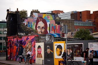 Vibrant street art mural and posters on urban wall