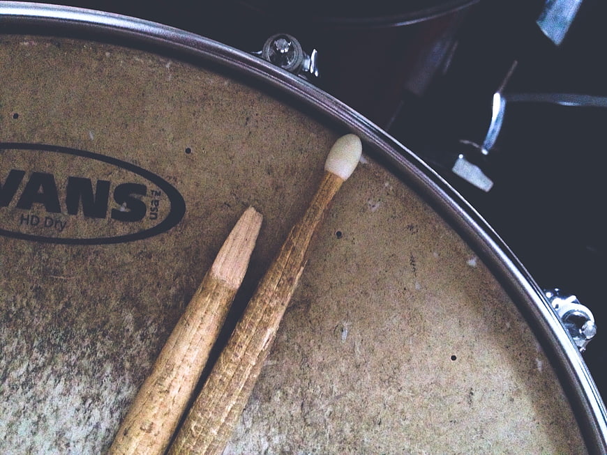 Close-up of worn drumsticks on a vintage snare drum head