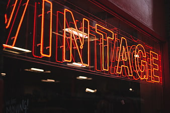 Red Vintage Neon Sign in Store Window at Night
